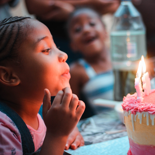 Kid blowing candle on her cake