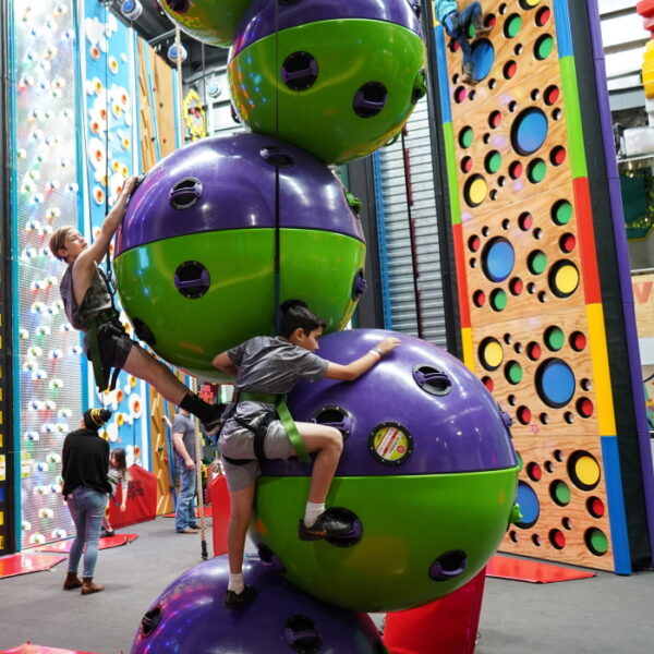 Kids climbing a giant ball close up