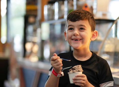 Kid enjoying a cup of ice cream